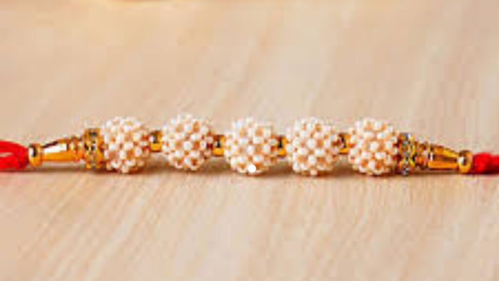 Royal Pearl Rakhi With Golden Beads